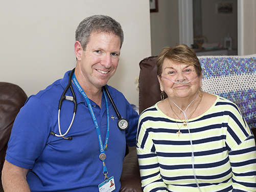 Care Dimensions RN Case Manager Rick Healy shares a pleasant moment with one of his hospice patients.