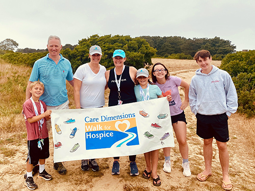 Alice Thomson RN and family with Care Dimensions Walk for Hospice sign