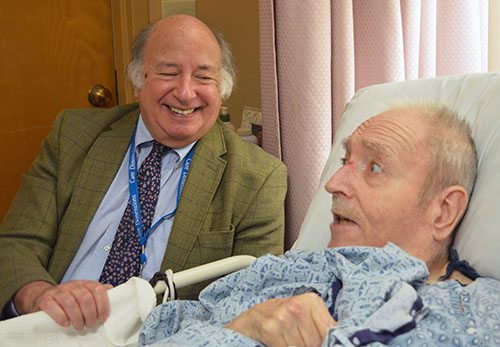Care Dimensions hospice volunteer Bill Brisk chats with patient Wayne Boucher.