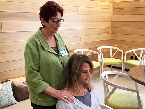 Hospice volunteer Charlene Cotting performs reiki at the Care Dimensions Hospice House in Lincoln, MA.