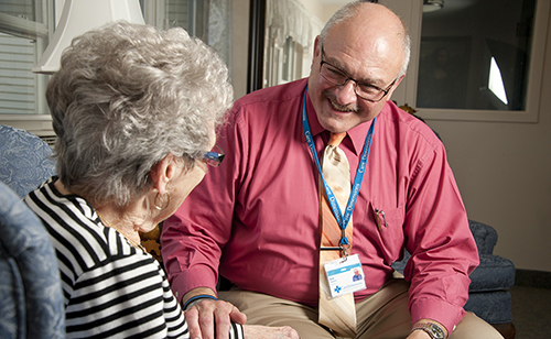 Care Dimensions chaplain Bob Hagopian speaks with female hospice patient