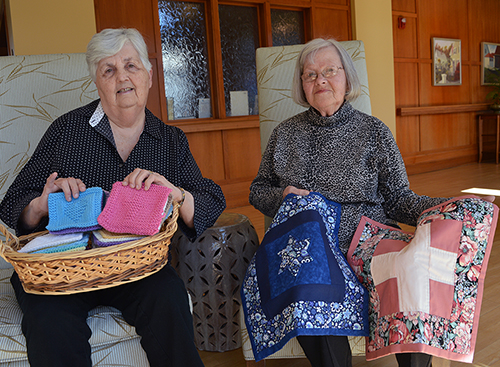 Community volunteers Henrietta Goodwin and Marilyn Brauss donate their talents to create prayer squares and quilts that are given to patients at Care Dimensions’ Kaplan Family Hospice House.