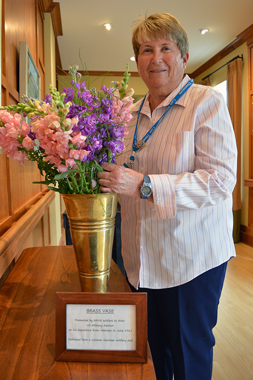 Care-Dimensions-hospice-volunteer-Kathe-Hyland-with-flowers-at-Kaplan-Family-Hospice-House