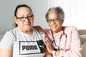 Wife of hospice patient smiling with Care Dimensions nurse