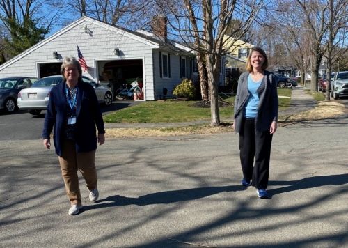 Care Dimensions Chaplain Beth Loughhead holds a walking bereavement visit with Tracey Armstrong in the age of social distancing. (Note: photo taken before outdoor mask advisories were issued in some communities.)