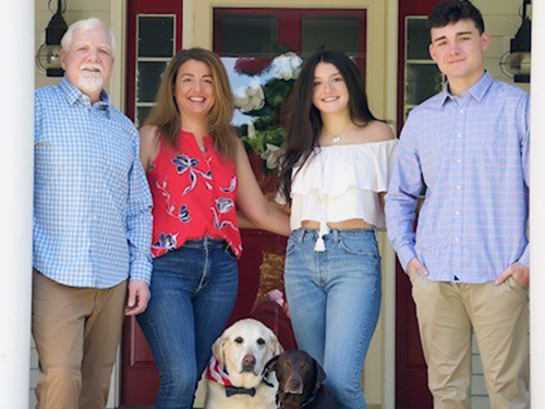 Craig, Robin, Emily, and Andrew Gould with Tanner and Scout in 2020.