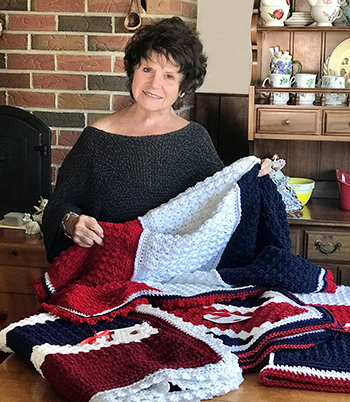 Diane Donnellan of Hugcrafters with patriotic afghans