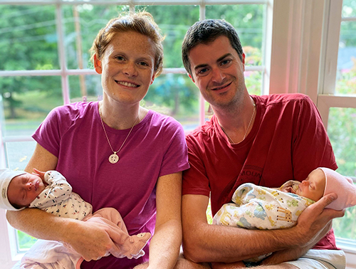 Laura and Rob Kirkpatrick hold twins Leah (left) and Julia (right).