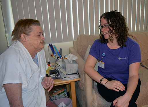 Care Dimensions Social Worker Jennifer Sheng meets with a hospice patient at home. (Photo taken prior to COVID-19 pandemic.)