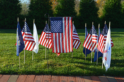 Flags honoring U.S. military veterans in the Garden of Remembrance at Care Dimensions' Kaplan Family Hospice House