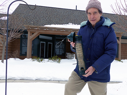 Volunteer Alan Wichlei helps any way he can at the Care Dimensions Hospice House, including refilling the birdfeeders.