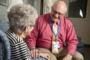 Care Dimensions chaplain Bob Hagopian with female hospice patient