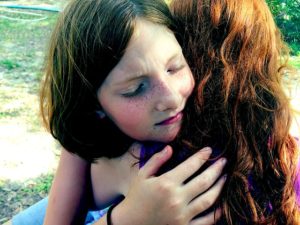 two teens hugging child grief support