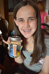 teen girl with memory lantern at Care Dimensions grief support group