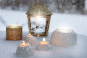 candles in snow managing grief during holidays