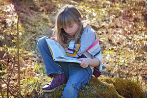 girl reading book coping with death, loss, and grief