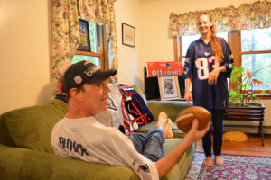 New England Patritos fan and Care Dimensions hospice patient Steve Brown catches football from daughter