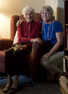 Care Dimensions admissions nurse Kitty Cunningham smiles with a female hospice patient at home
