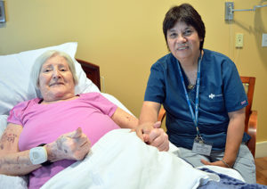 Care Dimensions Hospice Aide Cindy Berry visits with patient Anette Adams at the Kaplan Family Hospice House.