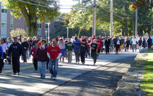 Crowd walking in street at start of Care Dimensions Walk for Hospice