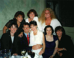 Kate Costin (front row, far right) and several Swampscott High School classmates, including Debbie Sentner (top row, right), celebrate Billy and Kelly Whalen’s wedding in 2001.