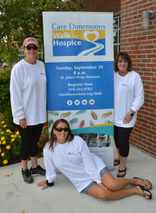 Three members of Swampscott, MA High School Class of 1985 with Care Dimensions Walk for Hospice sign